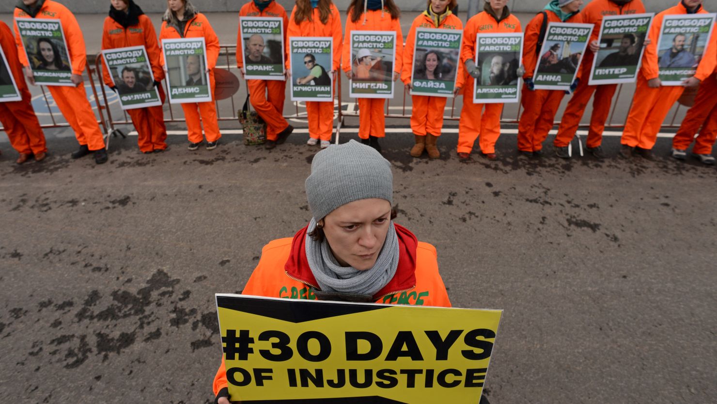Greenpeace activists hold pictures of the detained 'Arctic 30' activists as they demonstrate in Moscow, on October 18, 2013.