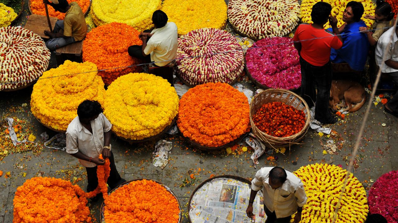 Indian vendors sell flowers for the celebration of the festival of Pongal, at the main wholesale market in Bangalore, on January 14, 2010. Pongal is a four-day-long 'harvest and thanks giving to nature festival' celebrated mainly in the southern Indian state of Tamil Nadu.