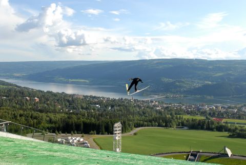 The ski jump facilities can be used all year thanks to an artificial turf covering. Lillehammer and Lake Mjosa can be seen in the background.