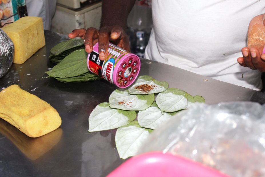 He sprinkles tobacco on each leaf, adding to the addictive nature of the betel quid.