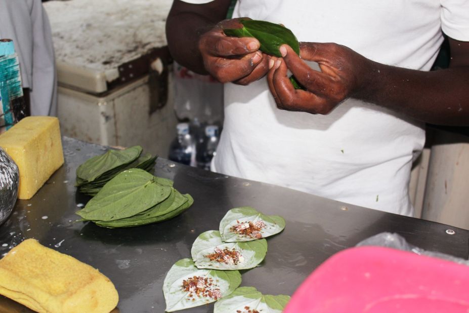 Kyaw Thet quickly rolls the leaves, tucking them into one hand while he works on the next. He sells them in packs of three for 100 Burmese kyat, around 10 U.S. cents.