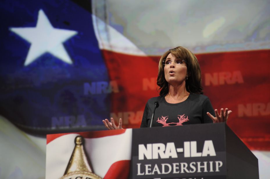 Wearing a shirt that reads "Women hunt," Palin blasts Obama and gun control advocates for "exploiting" recent mass shootings as she speaks to the National Rifle Association convention in Houston in May 2013.