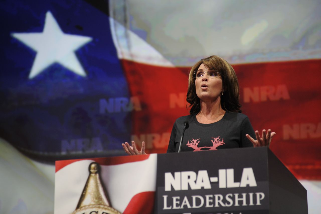 Wearing a shirt that reads "Women hunt," Palin blasts Obama and gun control advocates for "exploiting" recent mass shootings as she speaks to the National Rifle Association convention in Houston in May 2013.