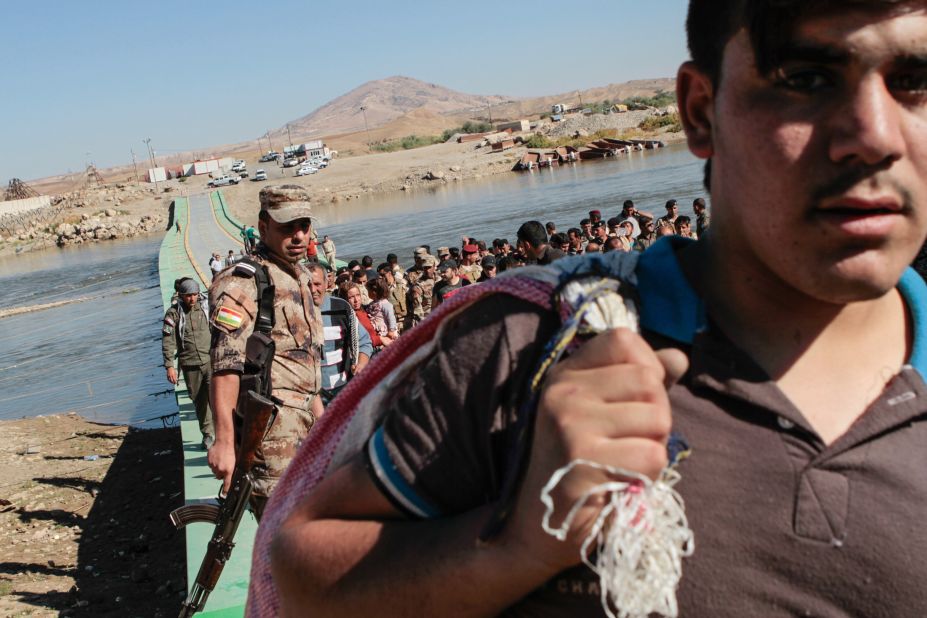 Syrian refugees are turned back after being refused entry into northern Iraq on Wednesday, October 23. 