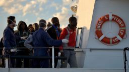 Some 100 migrants stand on the Guardia Costiera boat after being rescued off the shores of the island of Lampedusa on October 25, 2013. Two boats with other 219 migrants were picked up by Italian Navy ships deployed in Italy's new Mare Nostrum search-and-rescue operation, launched after more than 400 migrants drowned in two disasters earlier this month. Nearly 700 refugees were rescued off Sicily in several operations as European leaders grapple with the issue of illegal immigration at a European Union summit. AFP PHOTO / FILIPPO MONTEFORTEFILIPPO MONTEFORTE/AFP/Getty Images