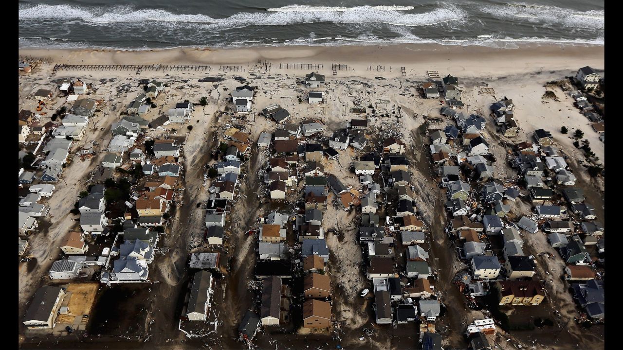 Homes in Seaside Heights, New Jersey, are surrounded by sand and debris on October 31, 2012.