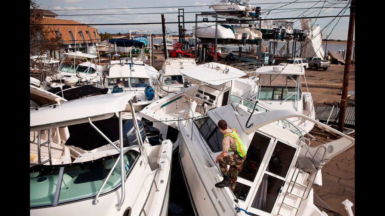 A volunteer surveys boats piled up by Superstorm Sandy on November 1, 2012 in Highlands, New Jersey.