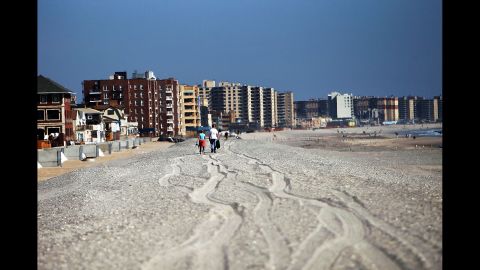People walk down the Rockaway beach on October 23.