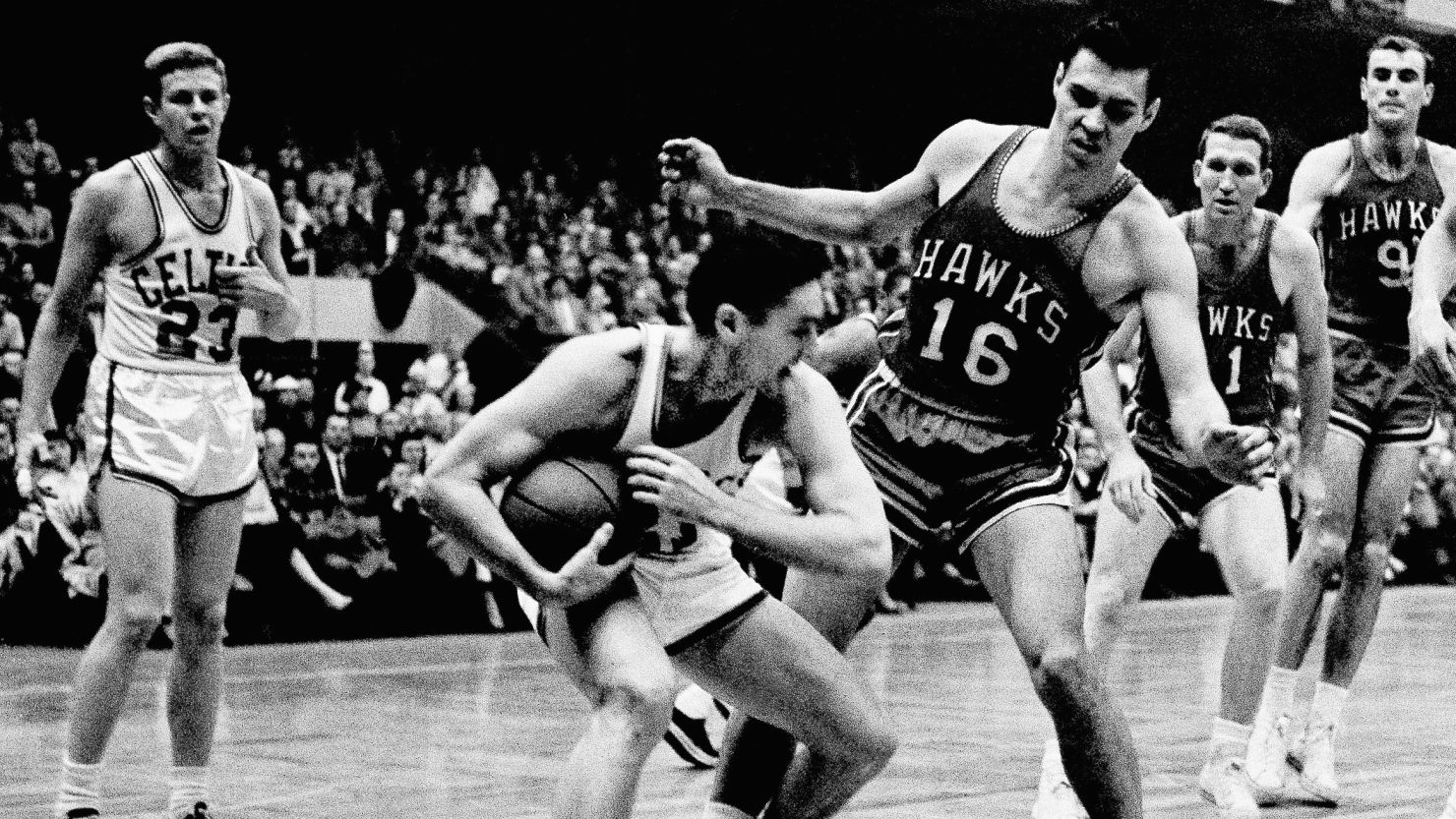 Bill Sharman draws coverage from St. Louis Hawks' Cliff Hagan during a March 30, 1958 game in Boston. 