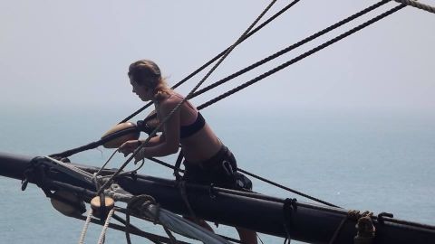 Hewitt checks sail rigging out on a yardarm. Maintaining a tall ship's hundreds of rope lines and multiple sails is complicated and dangerous work. 
