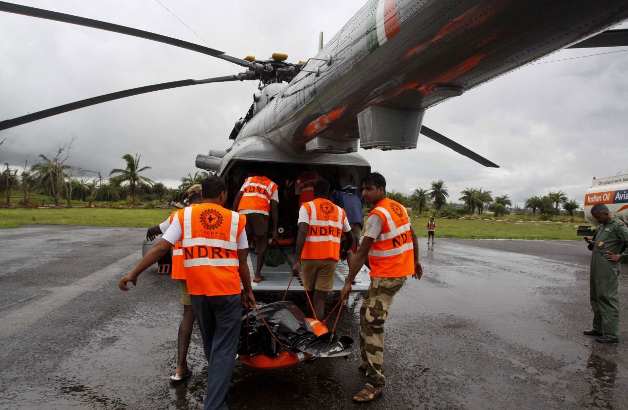 Rescue team members from the National Disaster Response Force load a chopper with rescue equipment in the Ganjam district of the eastern Indian state of Orissa on October 25.
