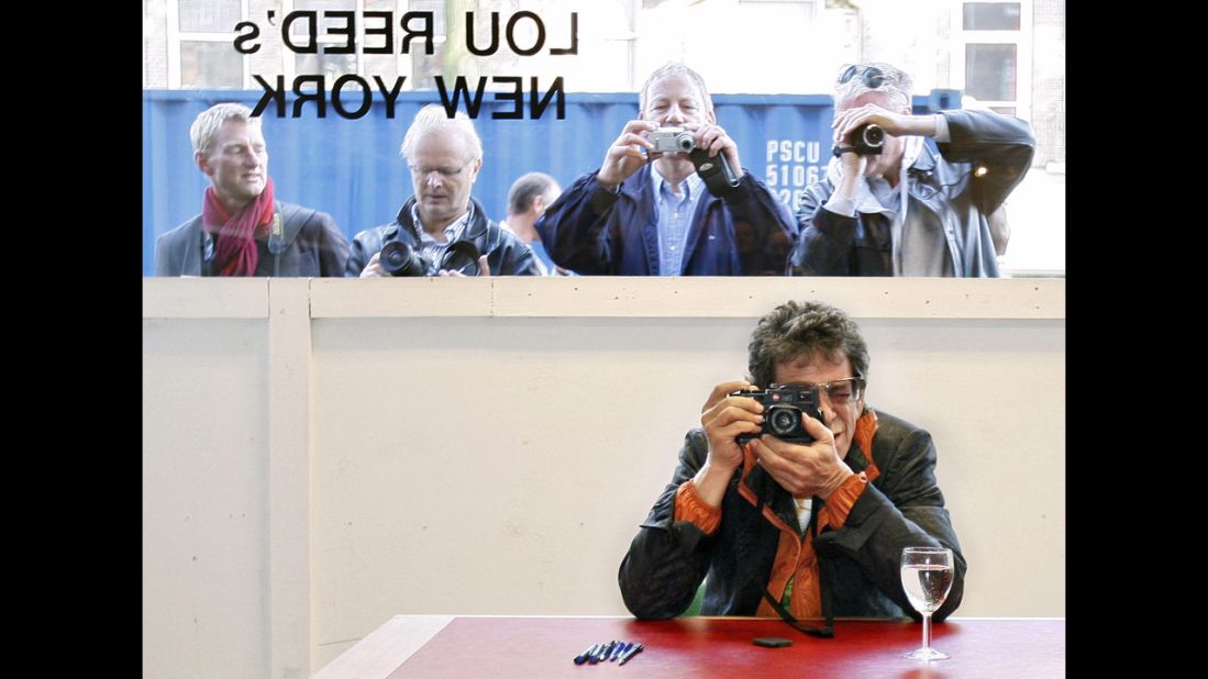 Reed takes a picture during the opening of his exhibition Lou Reed's New York in Serieuze Zaken Studioos, in Amsterdam on October 10, 2007.