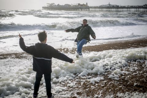 Father and son play on the beach in Brighton, England, on Sunday.