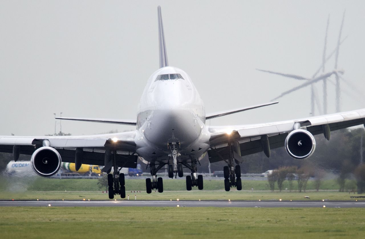 A plane lands with a tilted angle Monday on the runway of Amsterdam Schiphol Airport.