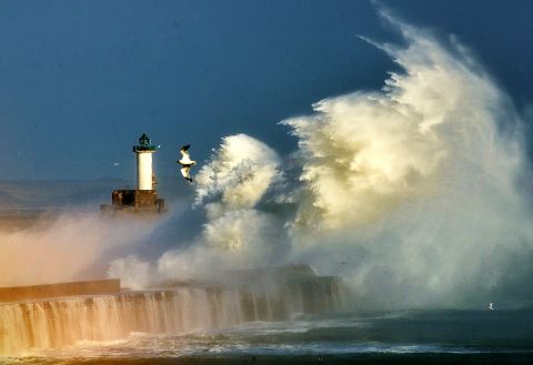 Large waves break against the dyke Monday at the port of Boulogne, France.