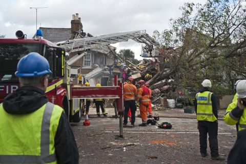 Emergency crews in London clear the wreckage of a house after a fallen tree caused a gas explosion there Monday, October 28. A major Atlantic storm brought wind gusts close to 100 mph Monday, knocking out power to thousands and disrupting travel in England, France, Belgium and the Netherlands.