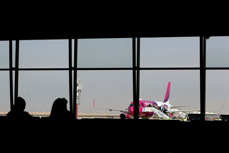 Passengers disembark from low cost Hungarian carrier Wizz Air -- the first commercial passenger flight to land at the airport.