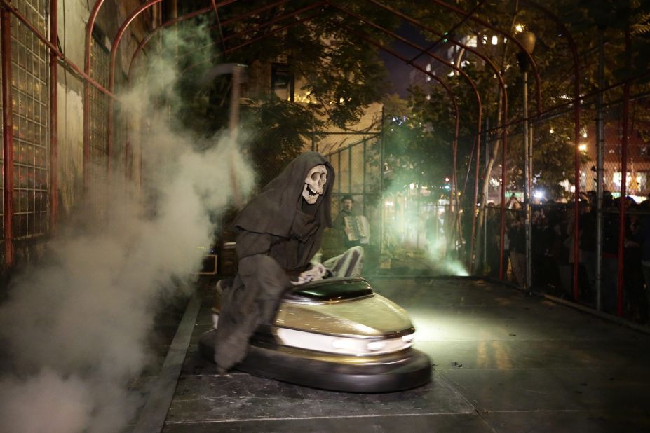 Banksy's art exhibit "Grim Reaper Bumper Car" sits on New York's Lower East Side in October 2013. The famously anonymous artist, whose paintings regularly go for six figures at auction houses around the world, said he was on a "residency on the streets of New York."
