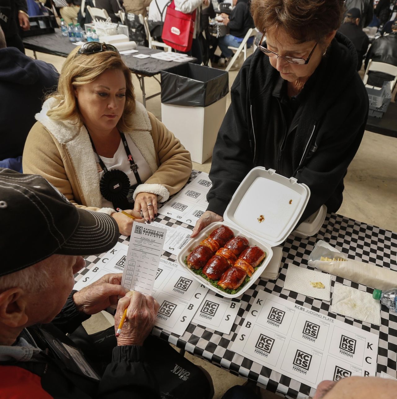 Before any tasting even begins, a table captain presents the meat to the judges for the 'appearance' score.
