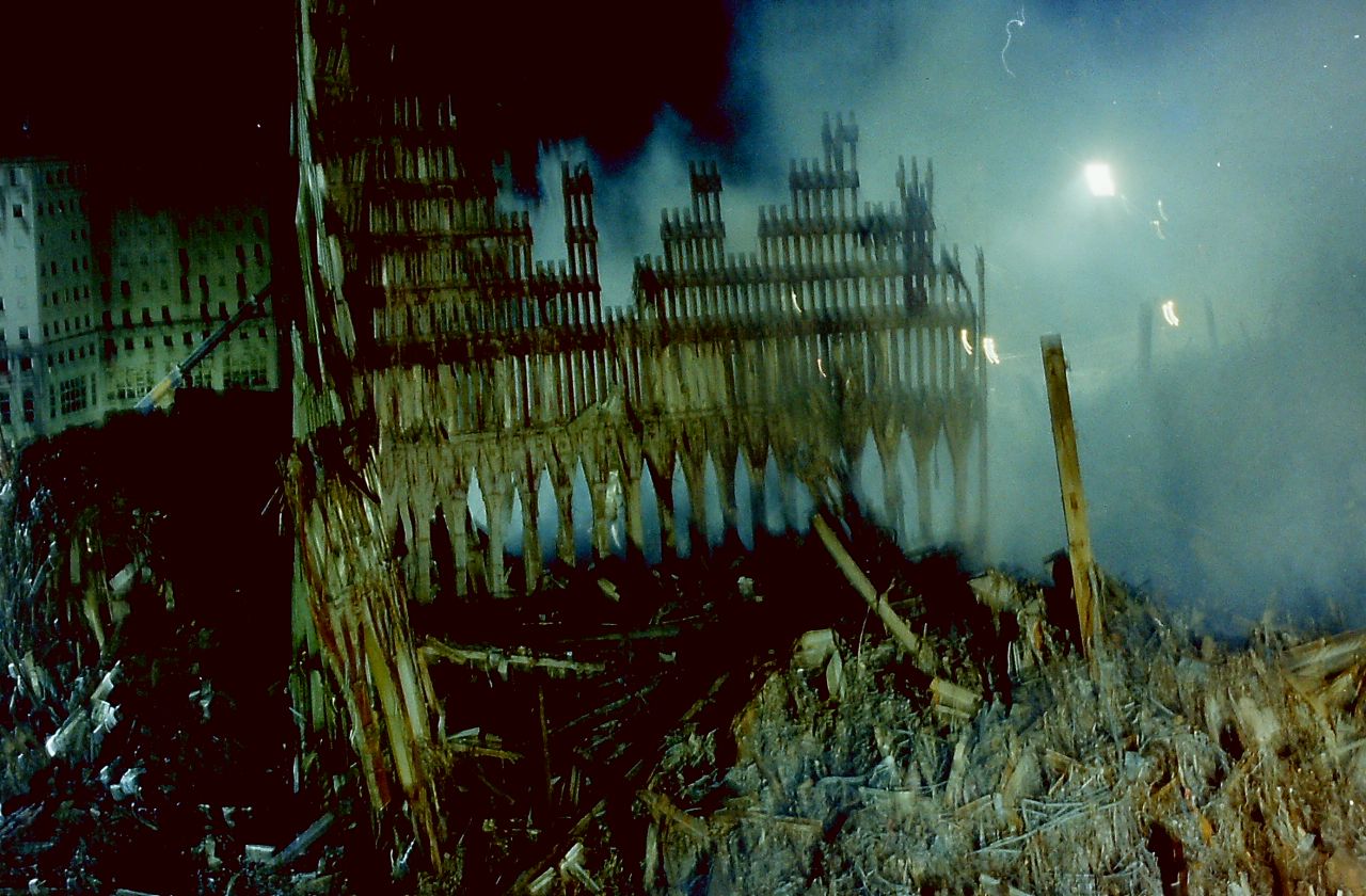 Sandy's murky floodwater added what appear to be superimposed black clouds to a photograph that shows piles of rubble and collapsed iron.