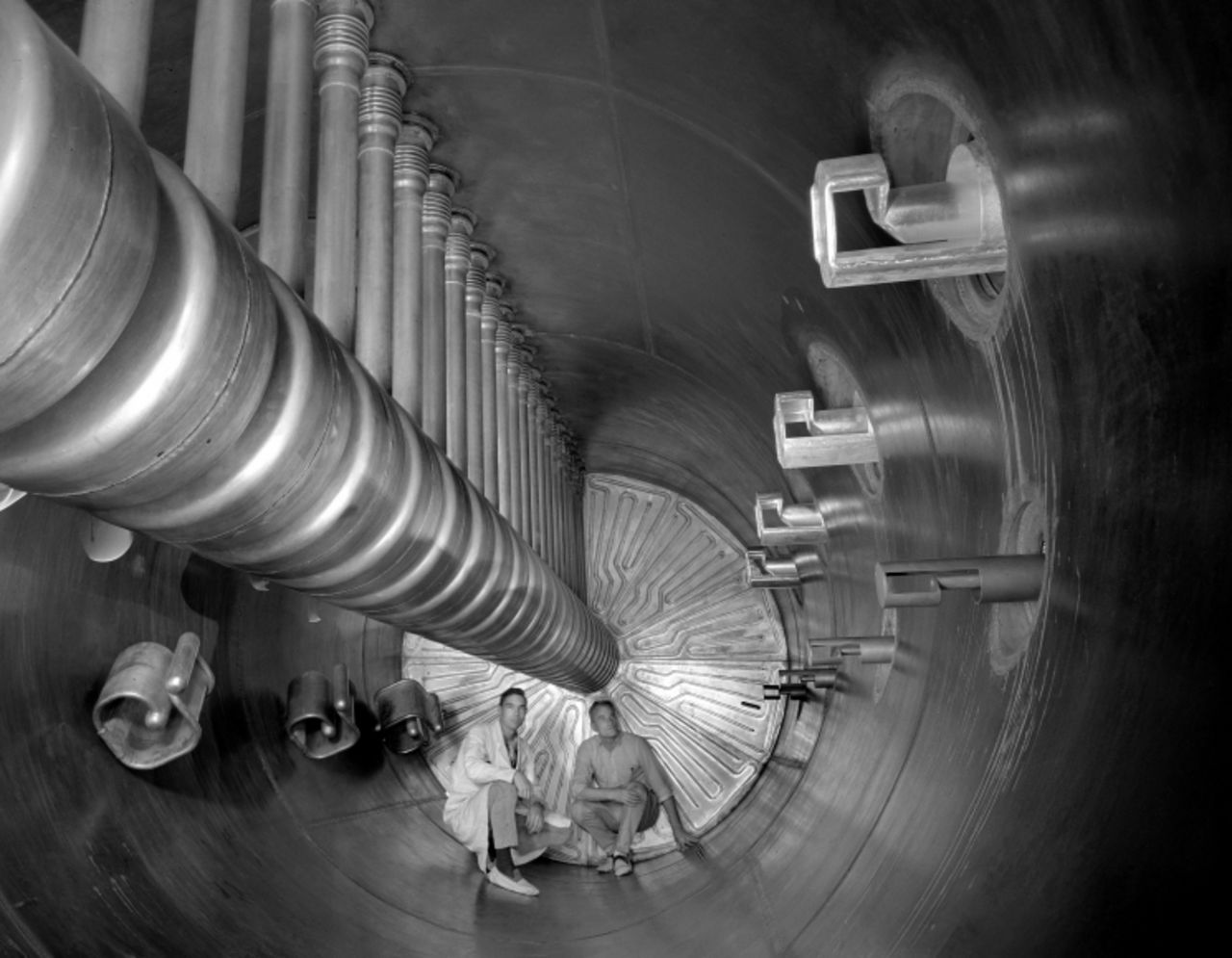 Two scientists show the scale of an earlier accelerator at the U.S. Department of Energy's Lawrence Berkeley National Laboratory. The Super HILAC (Super Heavy Ion Linear Accelerator) was one of the first accelerators that could accelerate the ions of all known natural elements to energies where they could be smashed apart. The lab is aptly named after Ernest Lawrence who invented the first circular accelerator at the University of California, Berkeley, back in 1929.