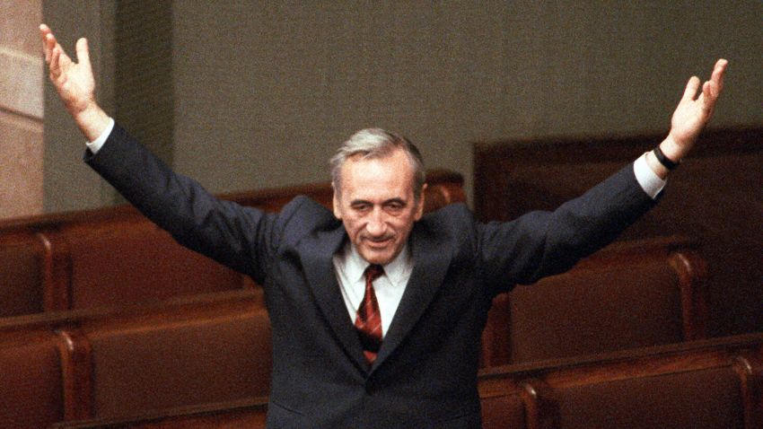 A file photo taken on September 12, 1989 shows Polish Prime Minister Tadeusz Mazowiecki triumphally saluting deputies from still empty government benches at the Parliament in Warsaw after the election of his cabinet.