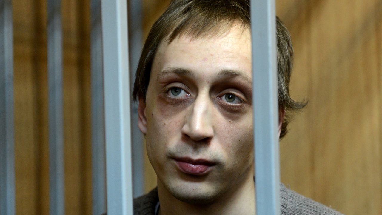 Pavel Dmitrichenko, a leading dancer at Russias Bolshoi Theatre, looks on as he stands inside the defendant's cage during a court hearing in Moscow, on October 22, 2013. 