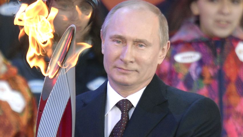 Russian President Vladimir Putin with the Olympic torch ahead of its relay across Russia.