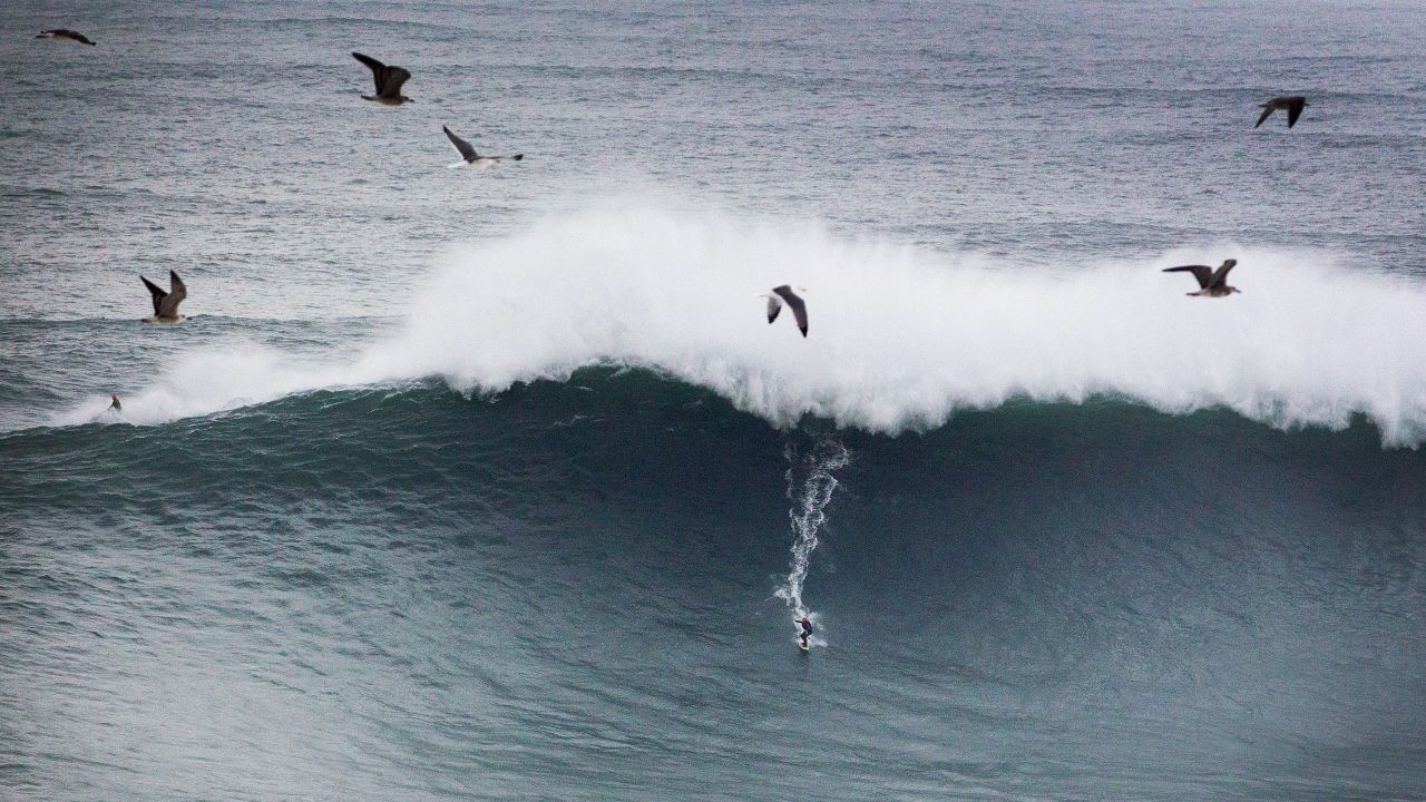 English surfer Andrew Cotton rides a wave at Praia do Norte on Monday. Praia do Norte, on Portugal's Atlantic coast, is renowned for its huge swells, and a storm on Monday brought more of them.