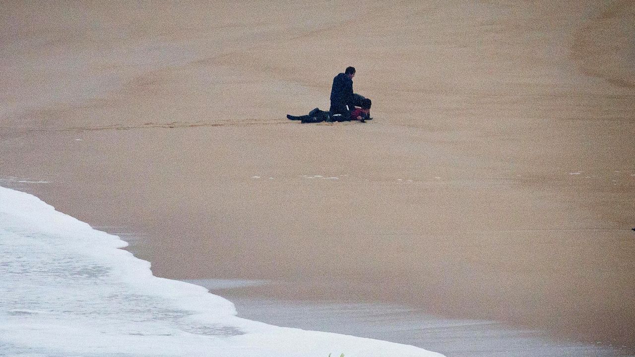 Surfers apply CPR to Gabeira on Monday. "She took the hardest beating I have ever seen by man or woman anywhere in the ocean and made it close to the shore all on her own," McNamara wrote on his Facebook page Tuesday.