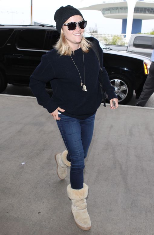 Reese Witherspoon dresses for warmth as she catches a flight on October 27. 