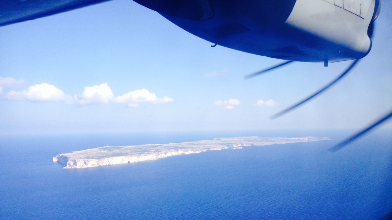 The view out of a window on the Frontex surveillance plane shows the Italian island of Lampedusa. More than 300 migrants died in a shipwreck while attempting to reach the island in early October.