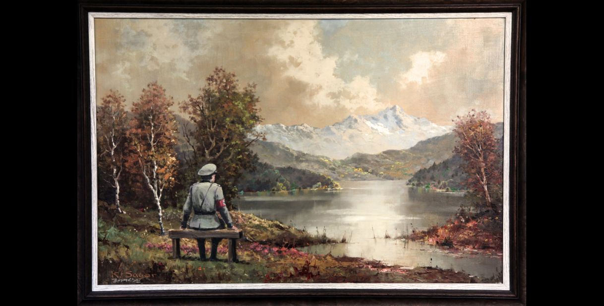 "The Banality of the Banality of Evil" actually started out as a thrift store painting in New York City. Once altered by Banksy, who inserted an image of a Nazi officer sitting on a bench, it was re-donated to the store in October 2013, according to the<a href="http://www.banksyny.com/" target="_blank" target="_blank"> artist's site</a>.