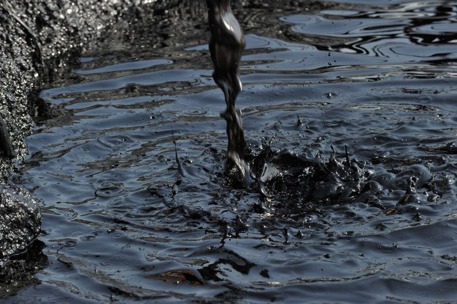 Tainted water pours into a containment pond in a Unity field processing facility in what is now South Sudan, where there are concerns about the environmental damage being caused by the oil industry.