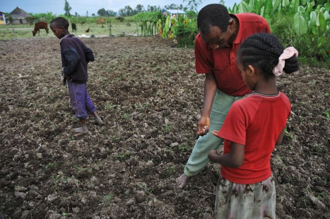 A farmer and his children plant a field with bean seeds and fertilizer in southern Ethiopia in 2008, a year after severe floods destroyed most of the food crop. Ethiopia is the country 10th most vulnerable to climate change effects, <a href="index.php?page=&url=http%3A%2F%2Fwww.cnn.com%2F2013%2F10%2F29%2Fworld%2Fclimate-change-vulnerability-index%2Findex.html">according to a 2013 report by Maplecroft</a>.