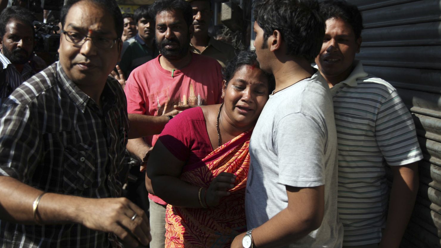 Relatives of passengers on board a crashed bus gather outside the offices of a the bus operator, Hyderabad, Oct. 30, 2013.