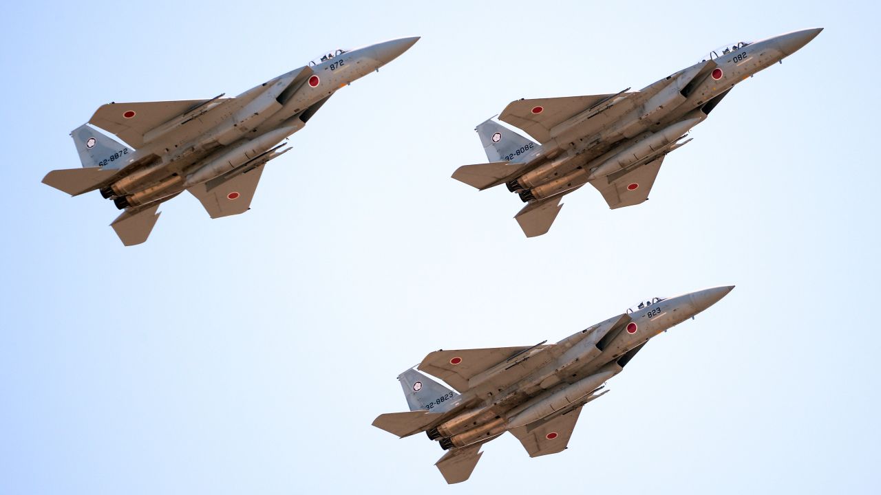 Japanese F-15 jets fly during a military review in 2013