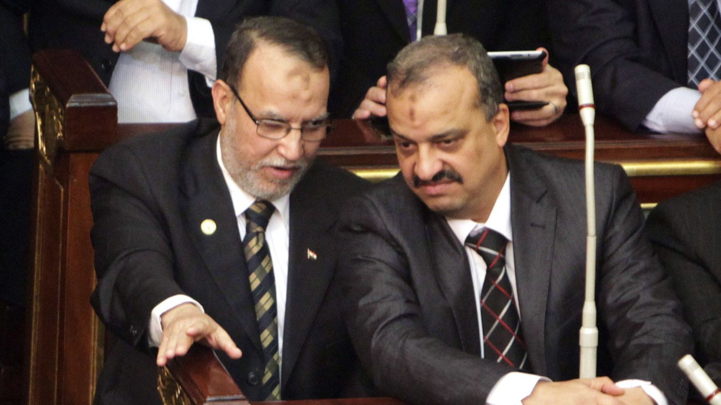 Essam el-Erian (left), and Muslim Brotherhood member Mohamed El-Beltagy talk during a parliament session in Cairo.