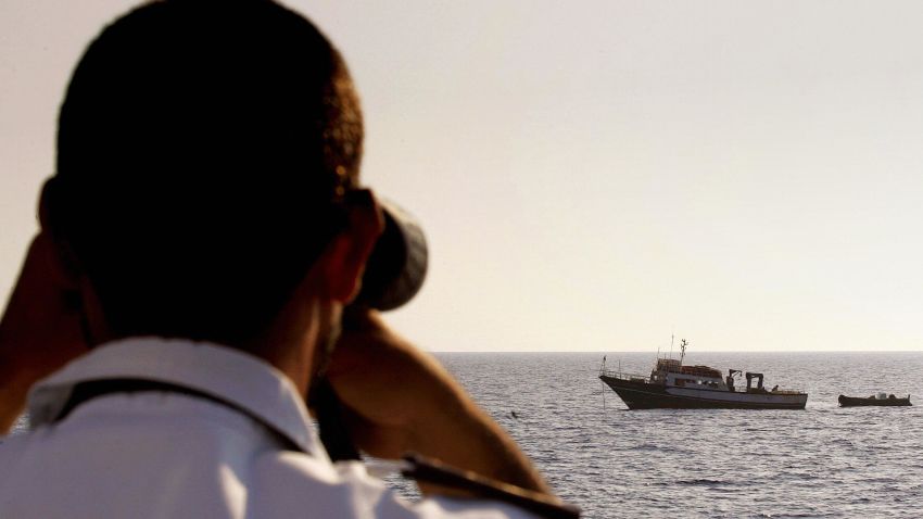 An Italian coast guard officer checks a Tunisian fishing boat in the Mediterranean 29 July 2004.