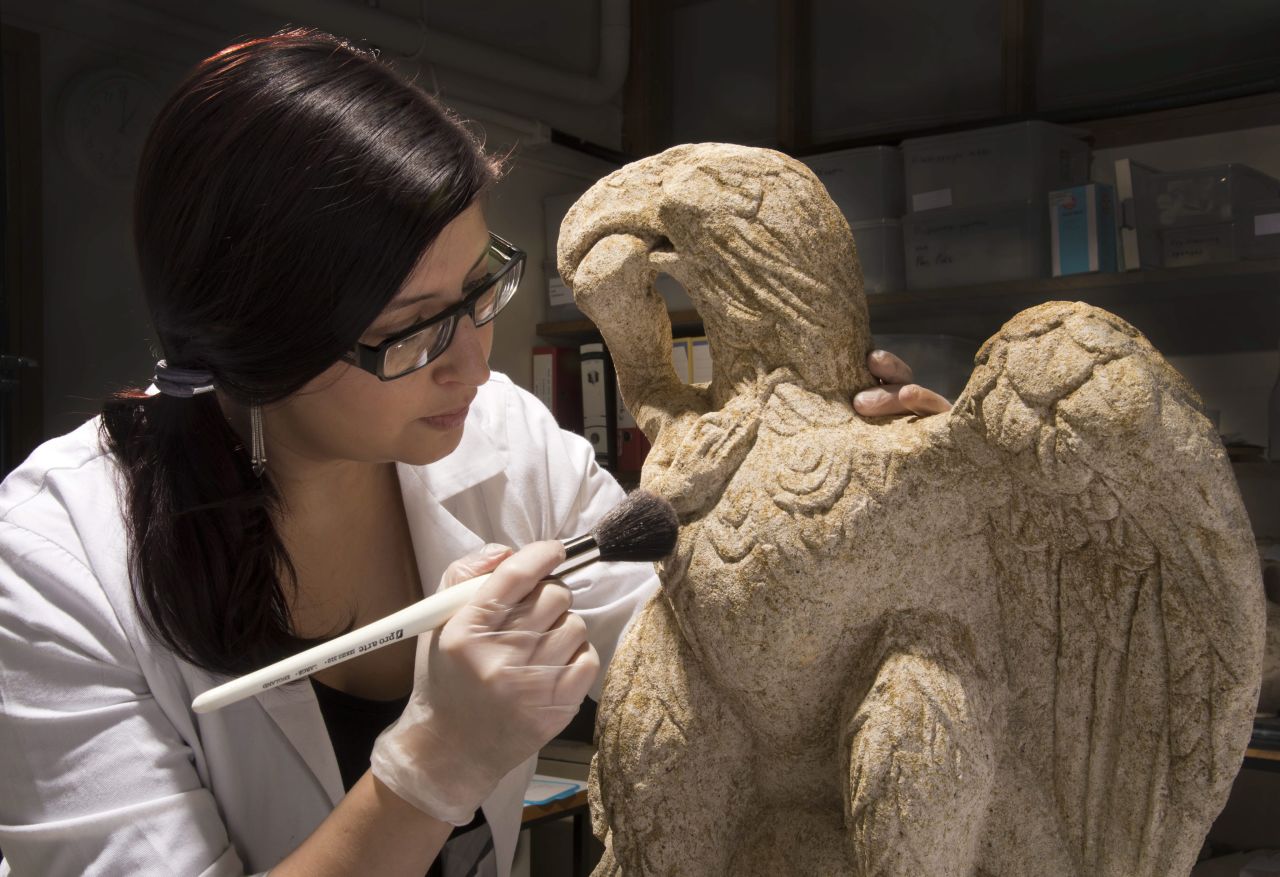 Museum of London Archaeology conservator Luisa Duarte dusts a Roman sculpture of an eagle clutching a serpent, dating from the first or second century. It was dug up at a site in the City of London, the UK capital's financial center, which is known once to have been home to a Roman cemetery. The statue is 26 inches tall and made of limestone. It will be on display at the Museum of London for the next six months.