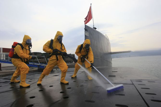 Soldiers clean and disinfect a nuclear submarine at the Qingdao submarine base in east China's Shandong province on July 17.