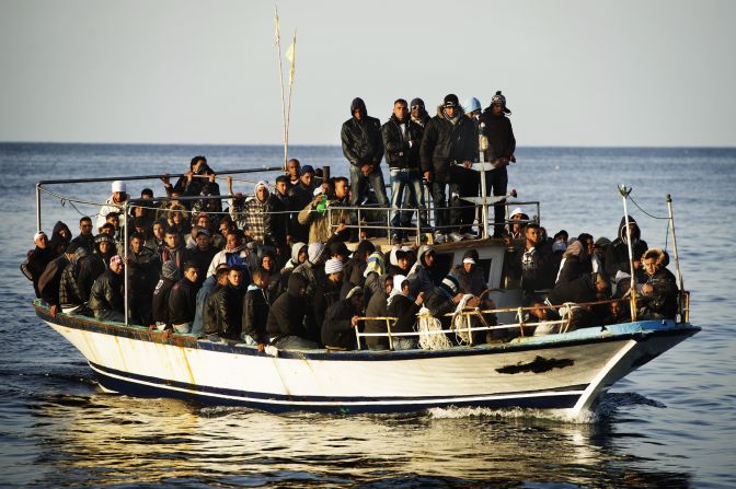 A boatfull of immigrants approaches the island in March 2011.