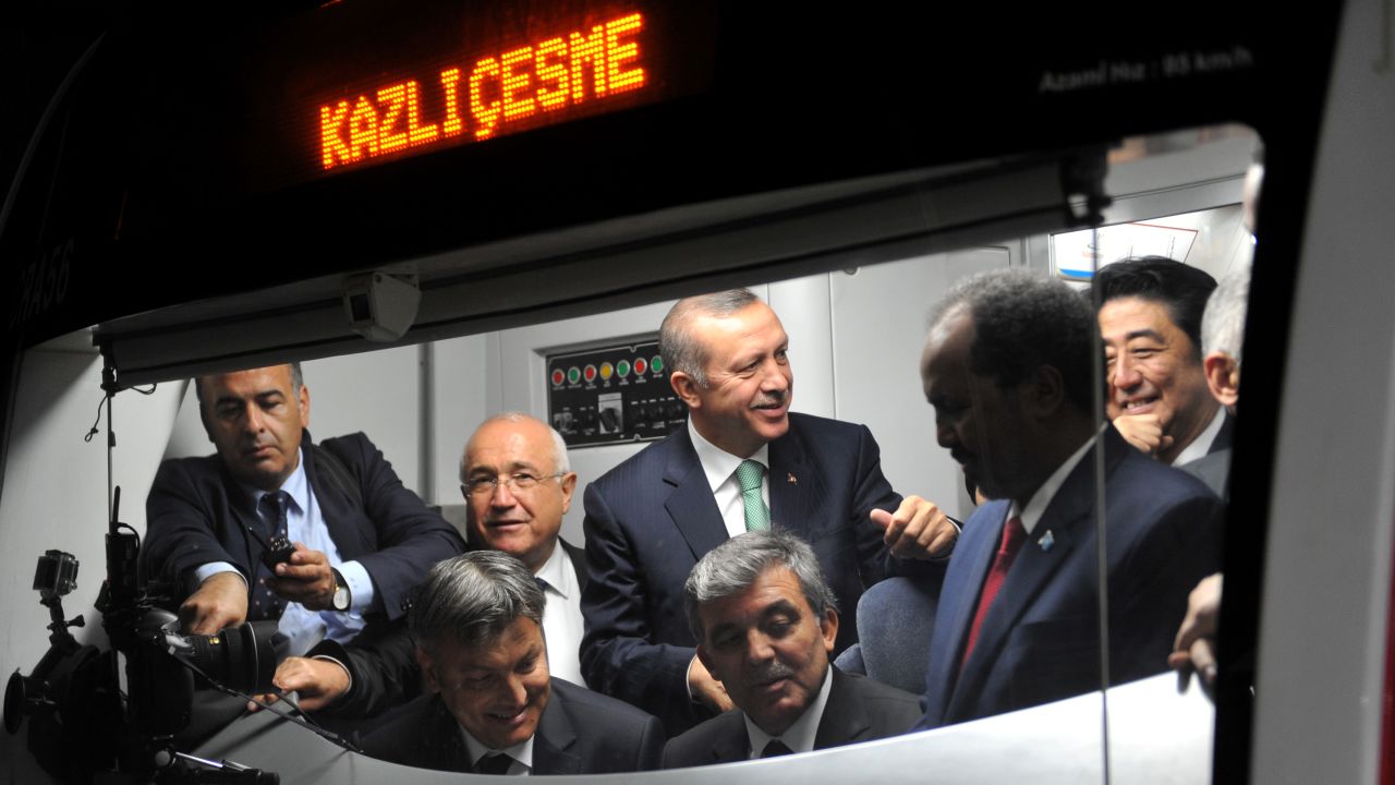 Turkish President Abdullah Gul, seated right, listens to a driver's explanations in the cabin of a Marmaray train Tuesday. Also in the cabin are Turkish Prime Minister Recep Tayyip Erdogan, behind Gul in the green tie; Somali President Hasan Sheikh Mahmud, second from right; and Japanese Prime Minister Shinzo Abe, far right.