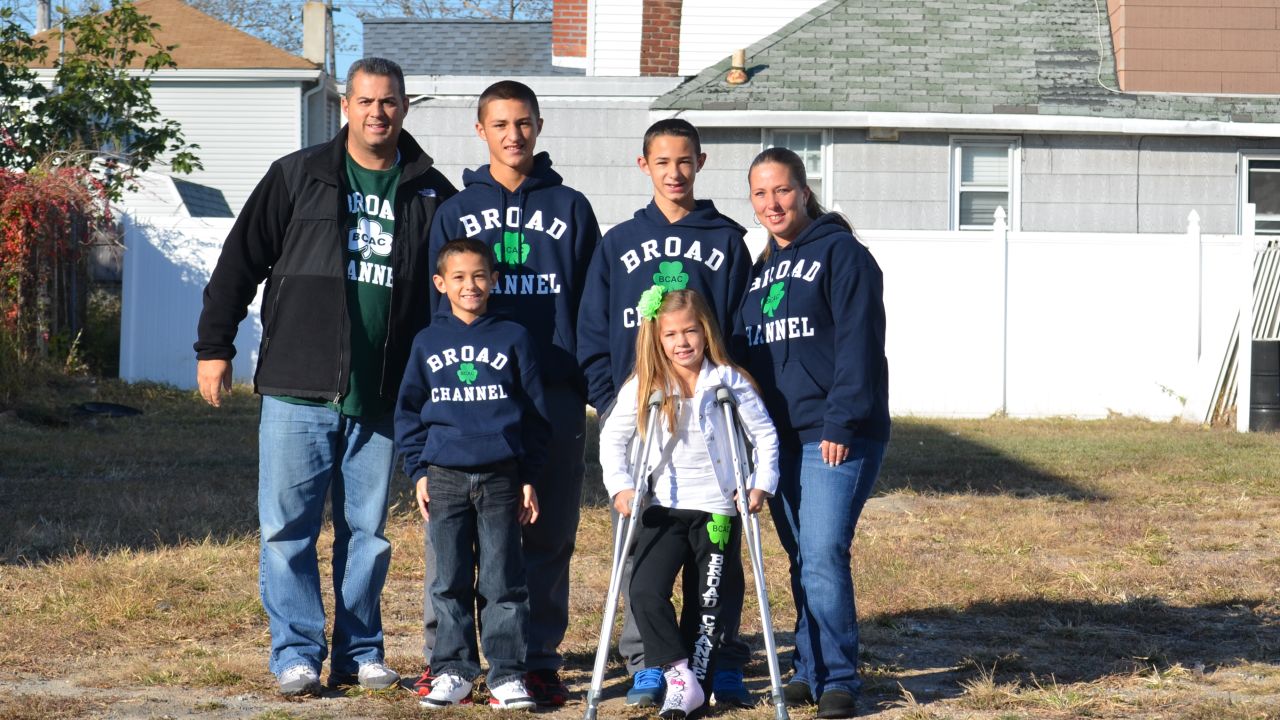 The Panetta family stands in the empty lot where their home once stood.