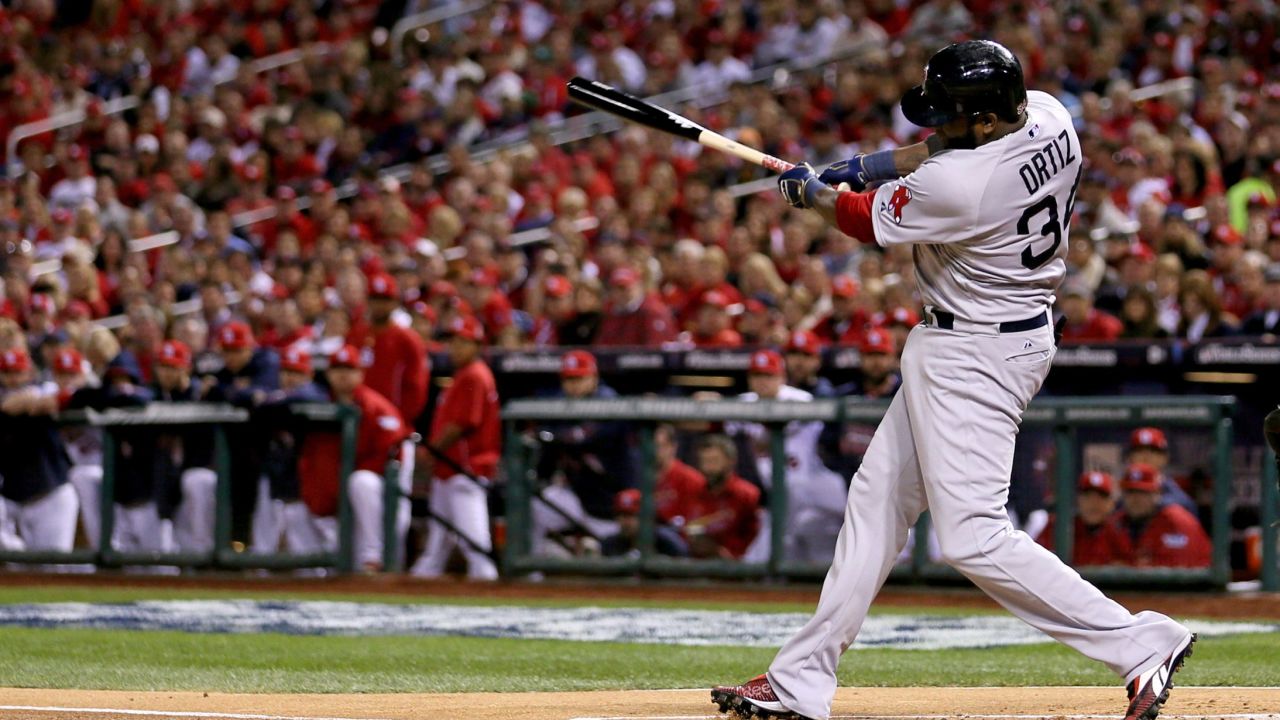 David Ortiz of the Boston Red Sox hits a double, scoring Dustin Pedroia, in the first inning against the St. Louis Cardinals during Game Five of the 2013 World Series.