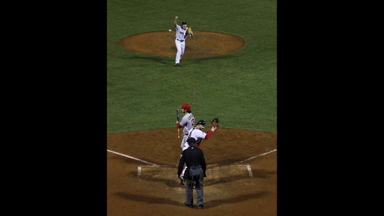 Red Sox relief pitcher Koji Uehara and catcher David Ross celebrate after striking out St. Louis Cardinals second baseman Matt Carpenter. 