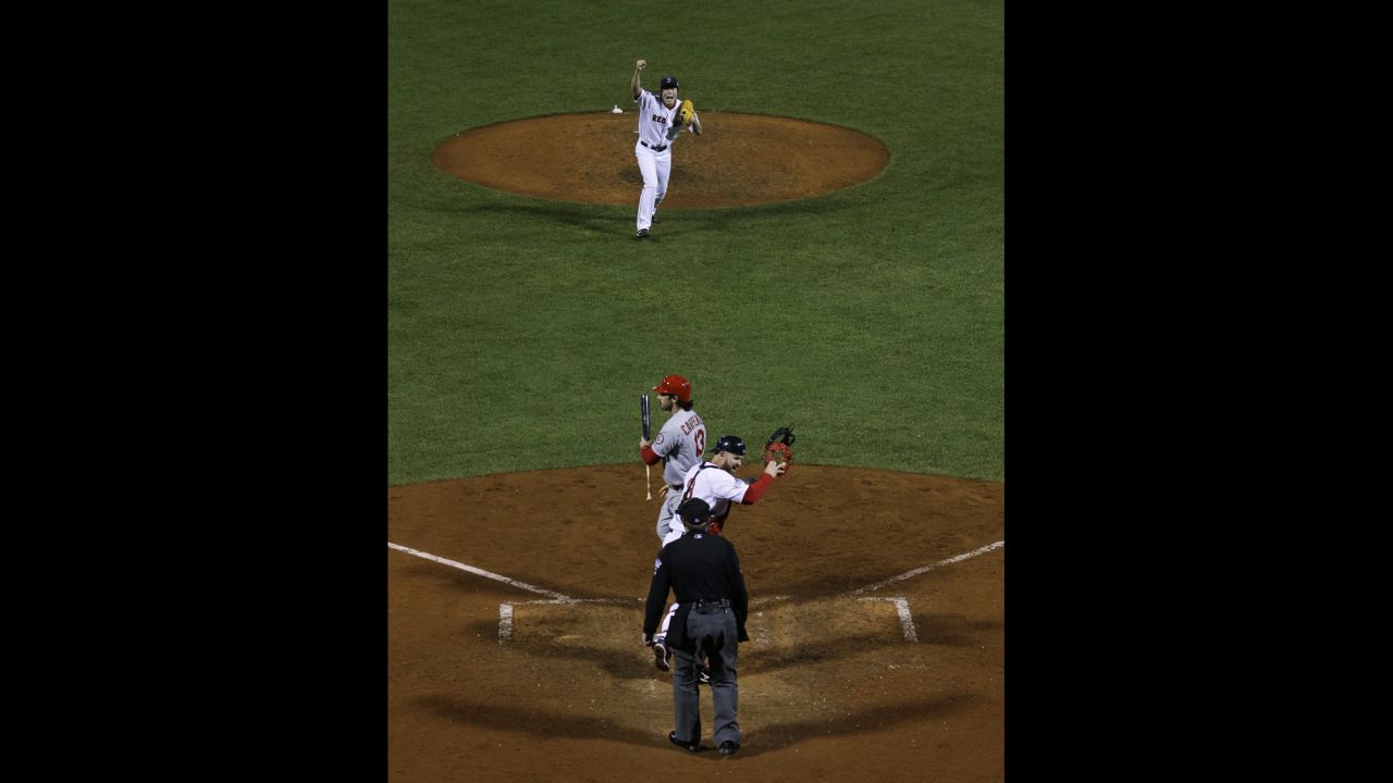 Red Sox relief pitcher Koji Uehara and catcher David Ross celebrate after striking out St. Louis Cardinals second baseman Matt Carpenter.