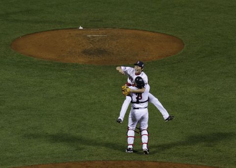 Boston Red Sox relief pitcher Koji Uehara jumps into David Ross' arms after defeating the St. Louis Cardinals. 
