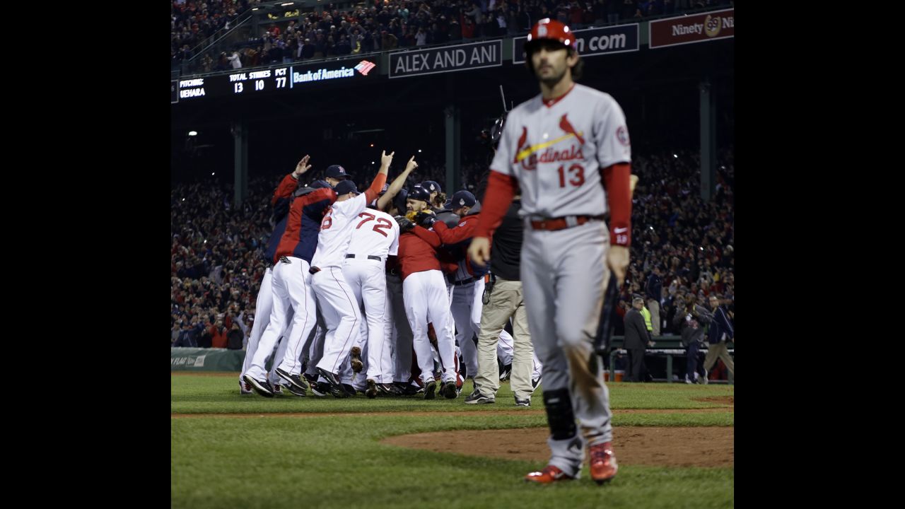 The Red Sox celebrate as St. Louis Cardinals second baseman Matt Carpenter leaves the field.