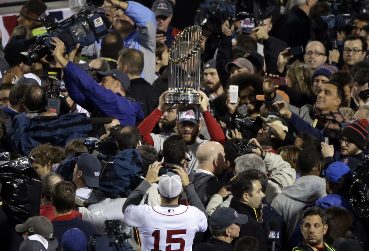 Boston Red Sox players hold up the championship trophy after Game 6 of baseball's World Series against the St. Louis Cardinals on Wednesday, October 30, in Boston. The Red Sox defeated the Cardinals 6-1. 